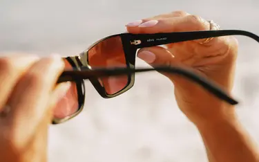 Black sunglasses with a beach background